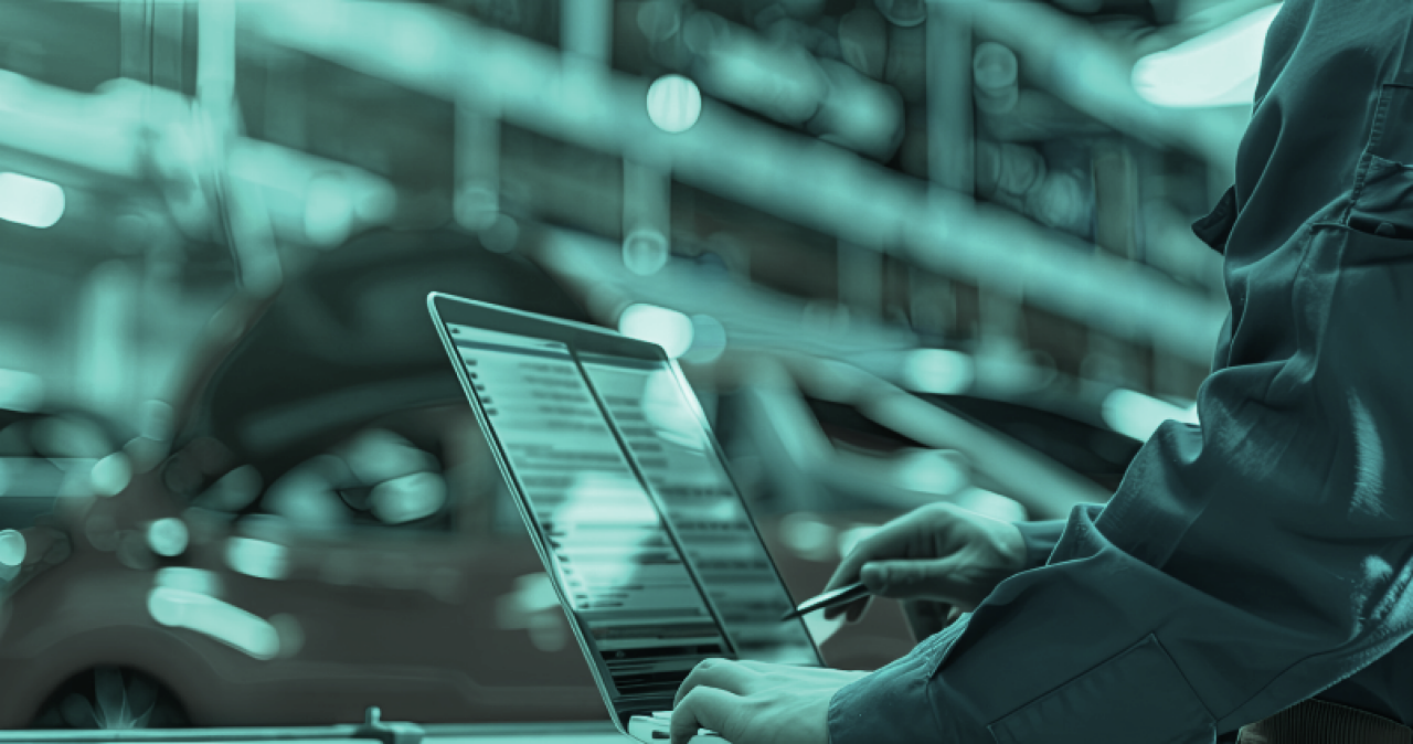 Person at workshop checking for Information on screen of Laptop.